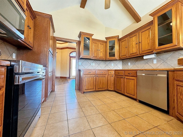 kitchen with stainless steel appliances, light tile patterned floors, tasteful backsplash, and beam ceiling