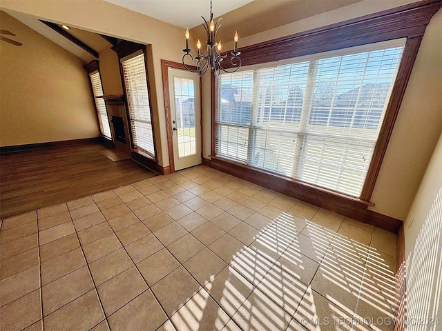 unfurnished dining area with a chandelier and hardwood / wood-style flooring