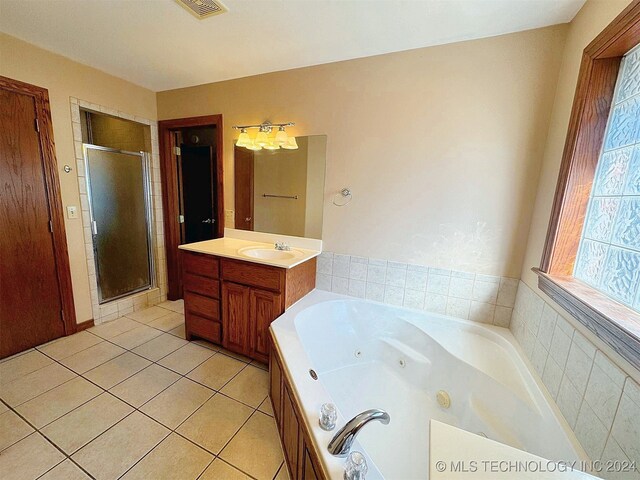 bathroom with vanity, tile patterned floors, and separate shower and tub