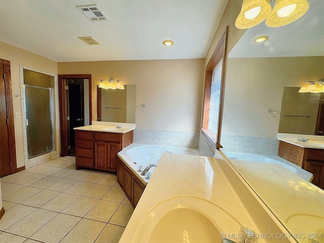 bathroom featuring independent shower and bath, vanity, and tile patterned floors