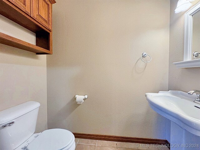 bathroom with tile patterned floors, toilet, and sink