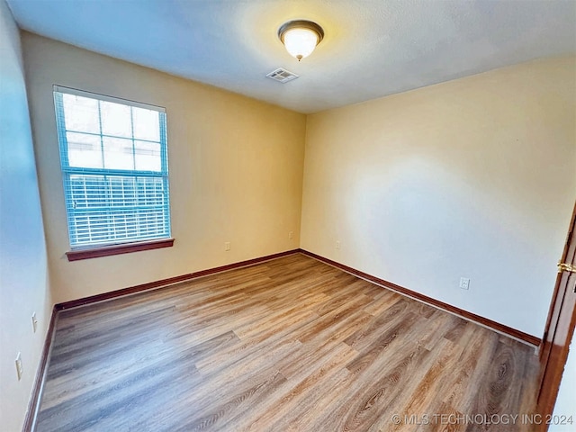 unfurnished room with light hardwood / wood-style floors