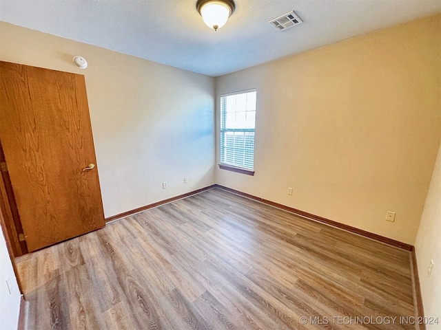 unfurnished room featuring hardwood / wood-style floors