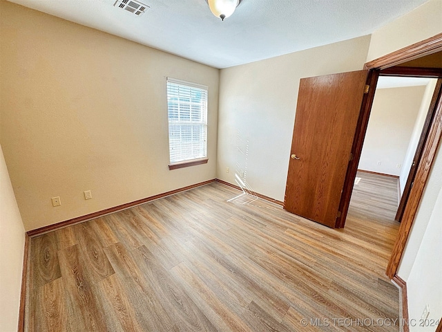 unfurnished bedroom featuring light wood-type flooring