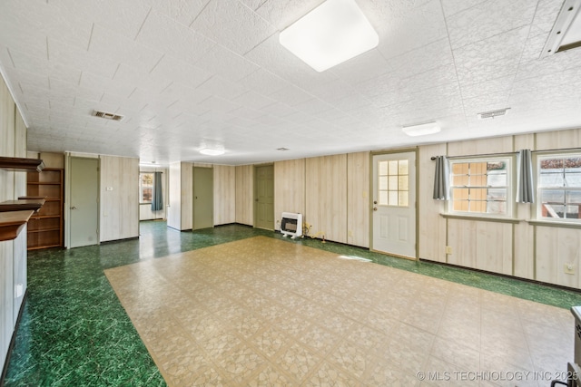 interior space with wood walls and a wealth of natural light