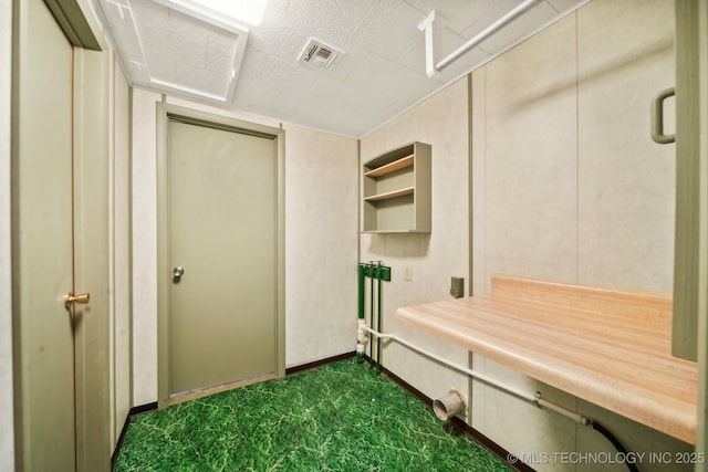 mudroom featuring dark colored carpet