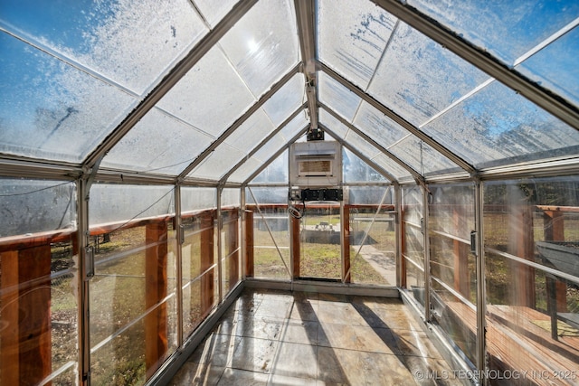 unfurnished sunroom with lofted ceiling