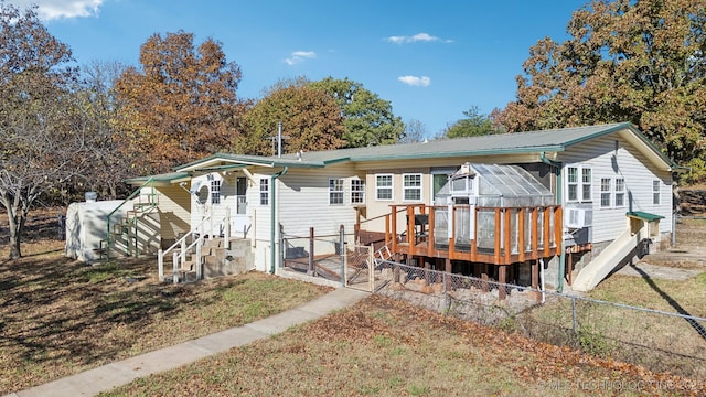 back of property with cooling unit and a deck