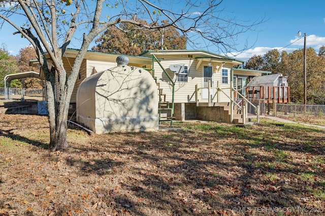 rear view of property featuring a carport