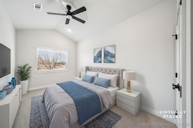 carpeted bedroom with ceiling fan and vaulted ceiling