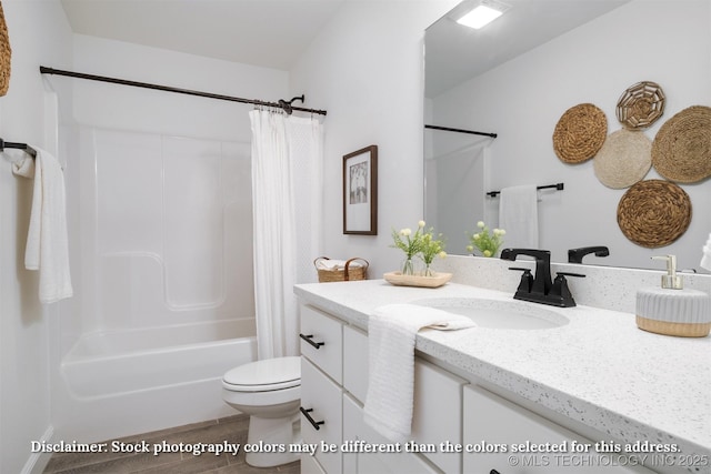 bathroom featuring shower / tub combo, vanity, and toilet