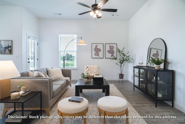 living area featuring a ceiling fan, wood tiled floor, baseboards, and visible vents