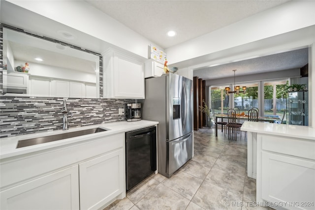 kitchen with dishwasher, stainless steel fridge, white cabinetry, and sink