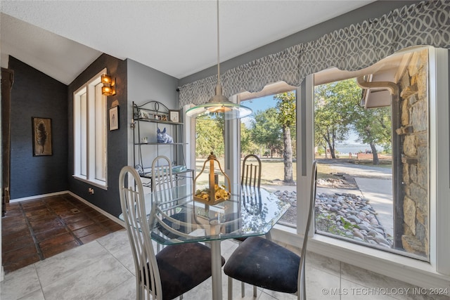 dining area featuring lofted ceiling