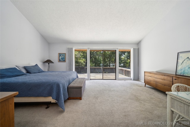 carpeted bedroom with access to outside, lofted ceiling, and a textured ceiling