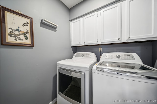 laundry room featuring cabinets and separate washer and dryer