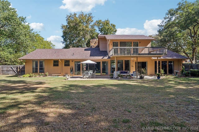 rear view of property with a lawn and a patio area