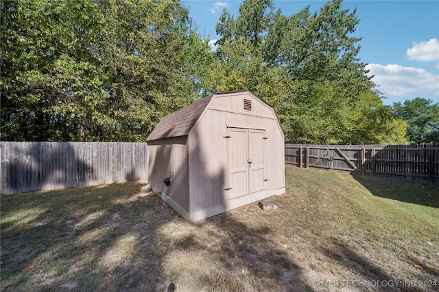 view of outdoor structure featuring a lawn