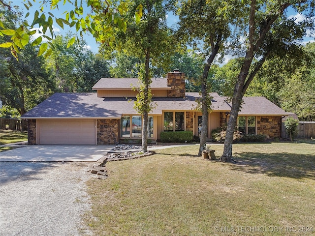 view of front of house with a front yard, french doors, and a garage