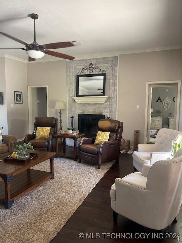 living room with a fireplace, dark hardwood / wood-style flooring, and ornamental molding