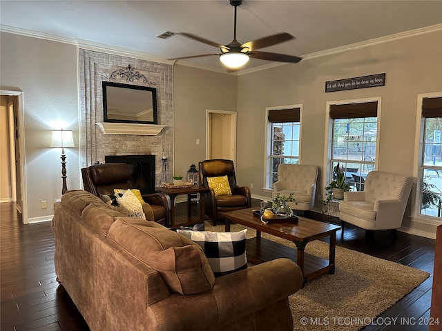 living room featuring a fireplace, dark wood-type flooring, ceiling fan, and crown molding