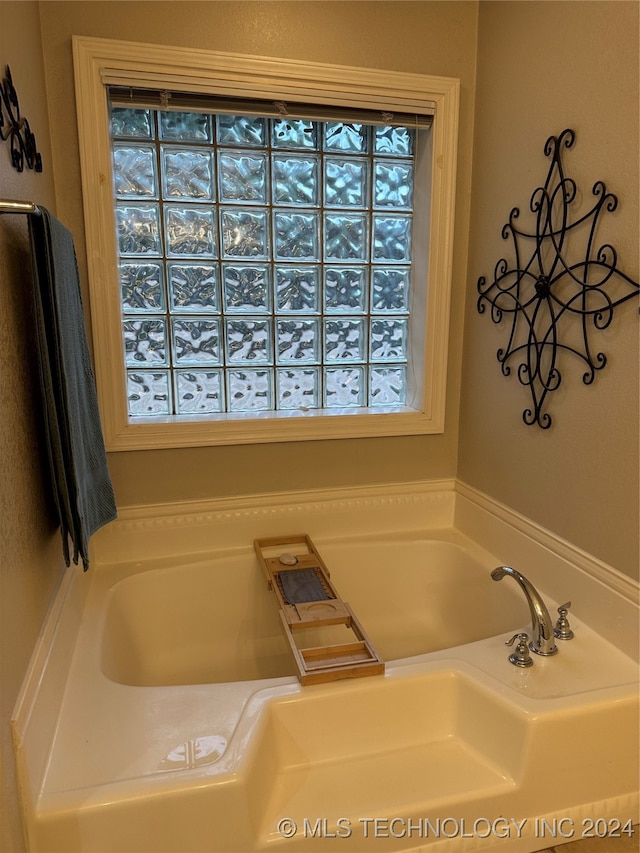 bathroom featuring a bathing tub and plenty of natural light