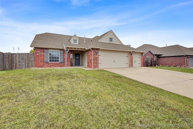 view of front of house featuring a garage and a front lawn