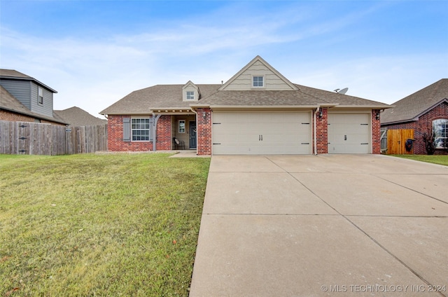 view of front of house with a front yard and a garage