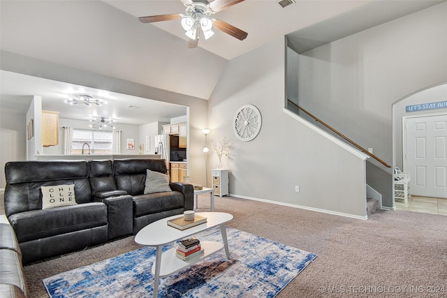 carpeted living room featuring ceiling fan and vaulted ceiling