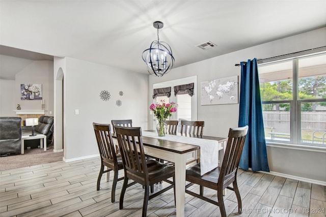 dining room featuring a wealth of natural light and an inviting chandelier