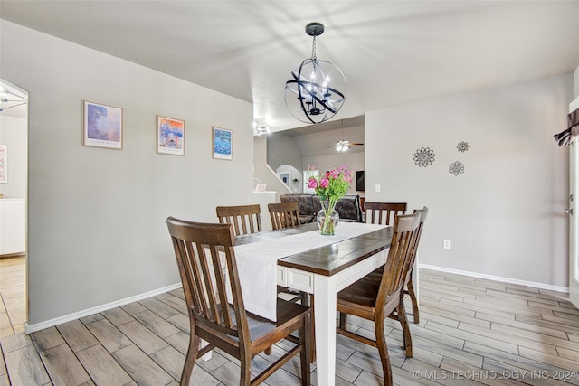 dining area featuring ceiling fan with notable chandelier