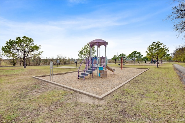 view of jungle gym featuring a lawn