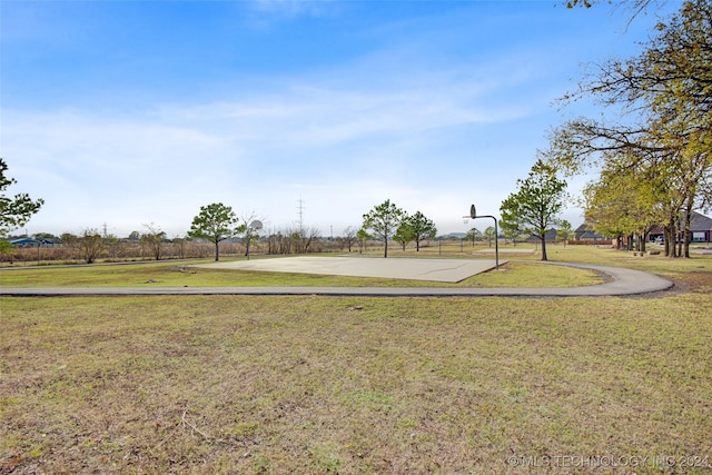 view of yard with basketball hoop