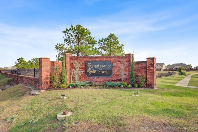 community / neighborhood sign with a lawn