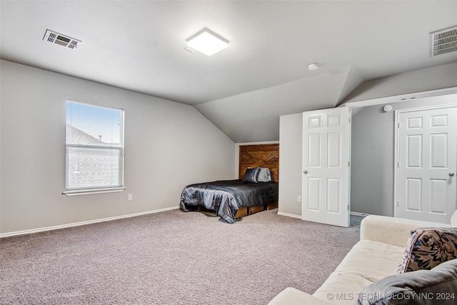 bedroom with lofted ceiling and carpet floors