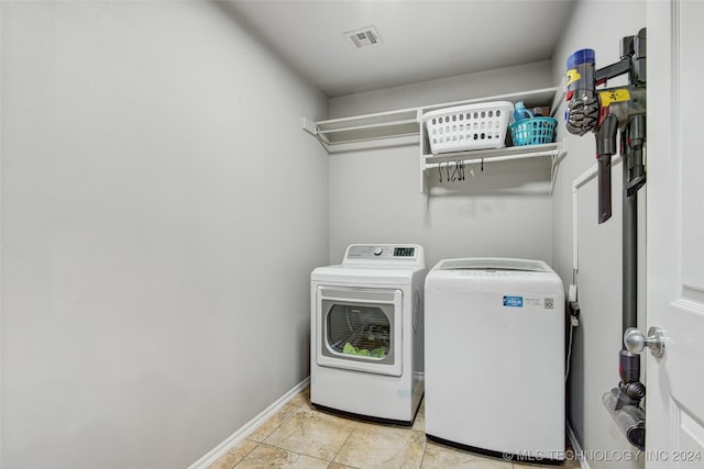 laundry room with separate washer and dryer