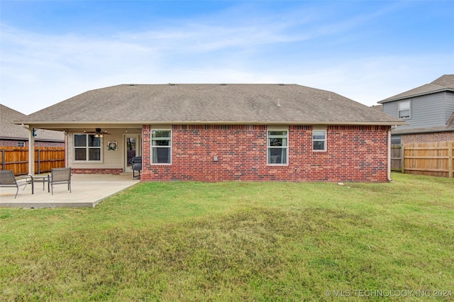 back of property featuring a yard, a patio, and ceiling fan