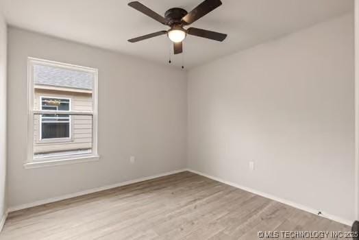 spare room featuring light wood-style floors, ceiling fan, and baseboards