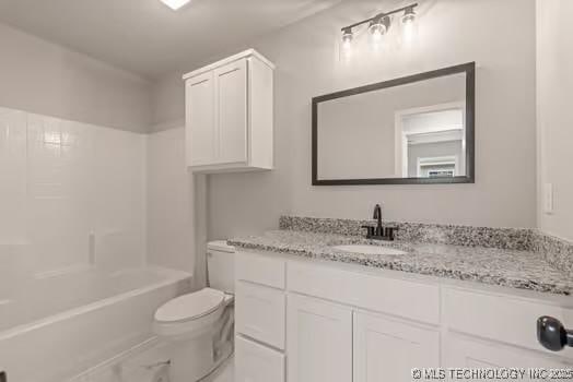 bathroom with shower / bath combination, vanity, and toilet