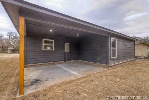 view of side of home featuring an attached carport