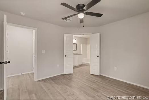 unfurnished bedroom featuring a ceiling fan, wood finished floors, visible vents, and baseboards