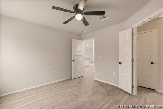 unfurnished bedroom featuring a ceiling fan, baseboards, visible vents, and light wood finished floors