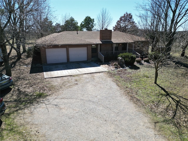 ranch-style house with a garage and a porch