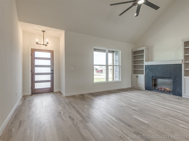 unfurnished living room with light wood-type flooring, a fireplace, and baseboards