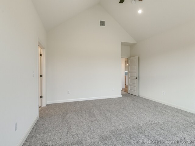 empty room with carpet floors, high vaulted ceiling, and ceiling fan