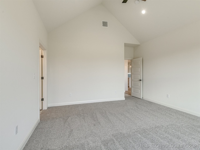 carpeted empty room with high vaulted ceiling, visible vents, ceiling fan, and baseboards