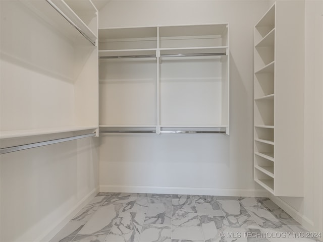 spacious closet with marble finish floor