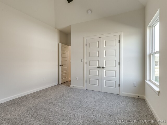 unfurnished bedroom with a closet and carpet flooring