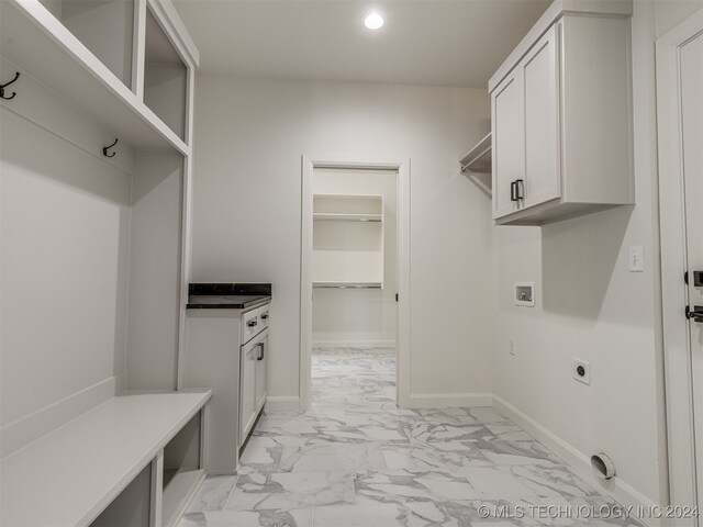 washroom featuring cabinets, washer hookup, and electric dryer hookup