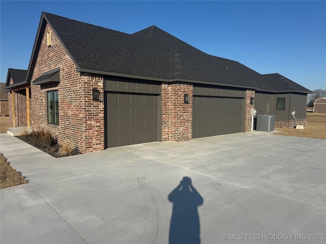 view of property exterior with concrete driveway, brick siding, roof with shingles, and an attached garage